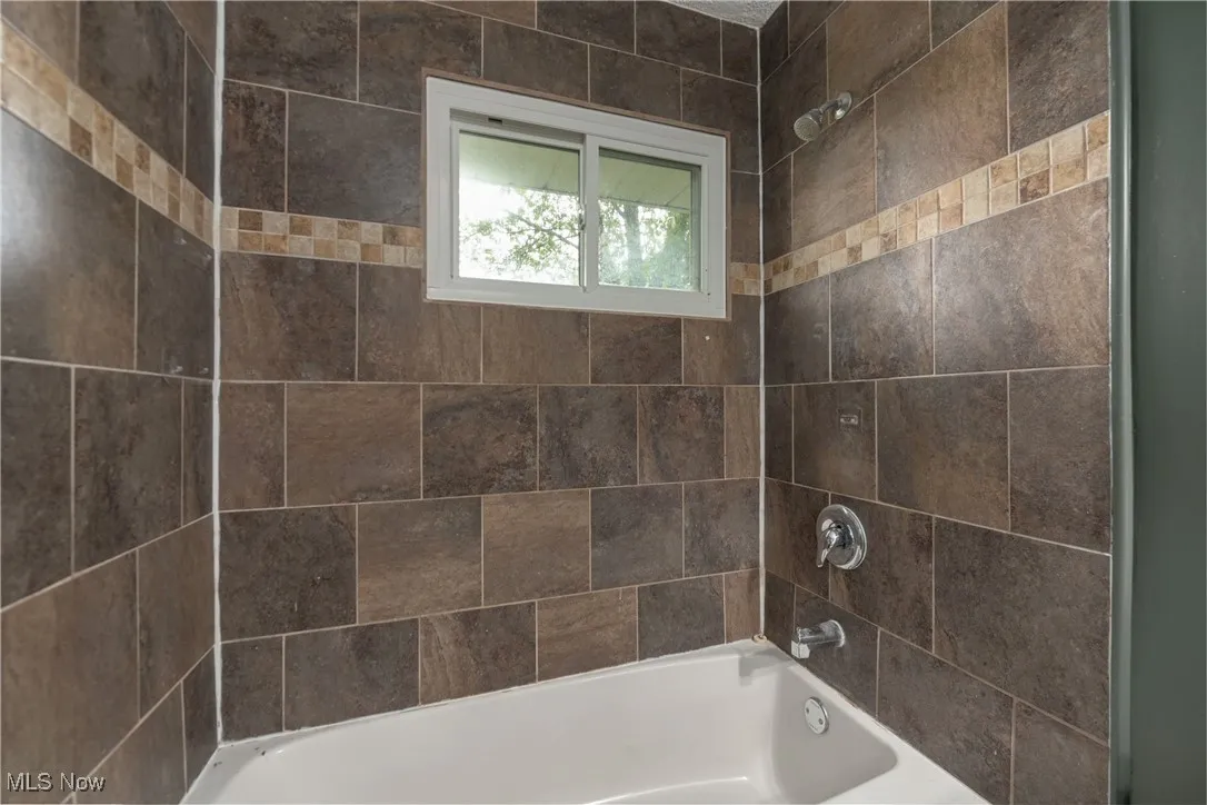 Full bath featuring shower / bath combination