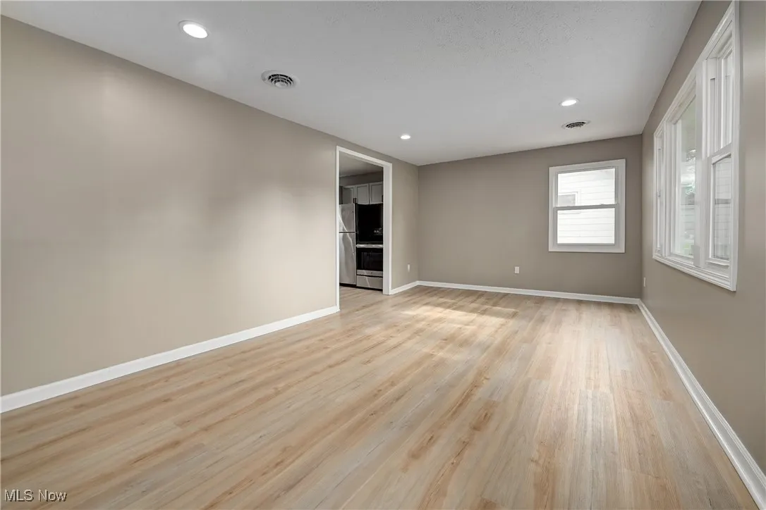 Empty room with recessed lighting and light wood finished floors