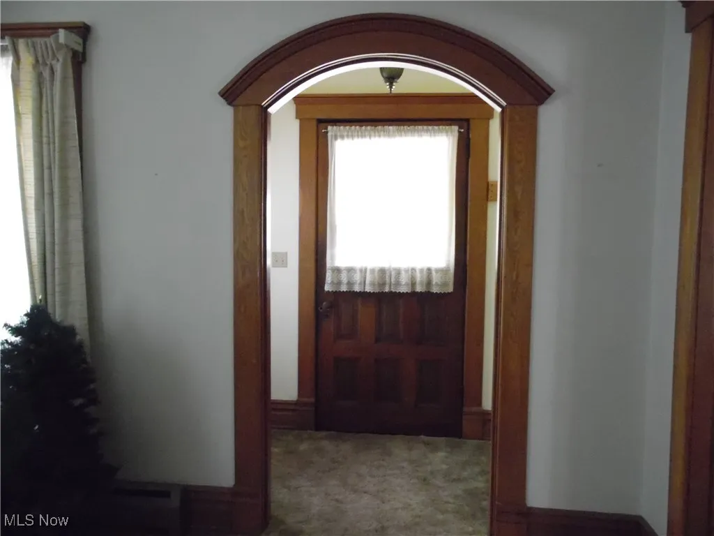 Doorway to outside with baseboards and arched walkways