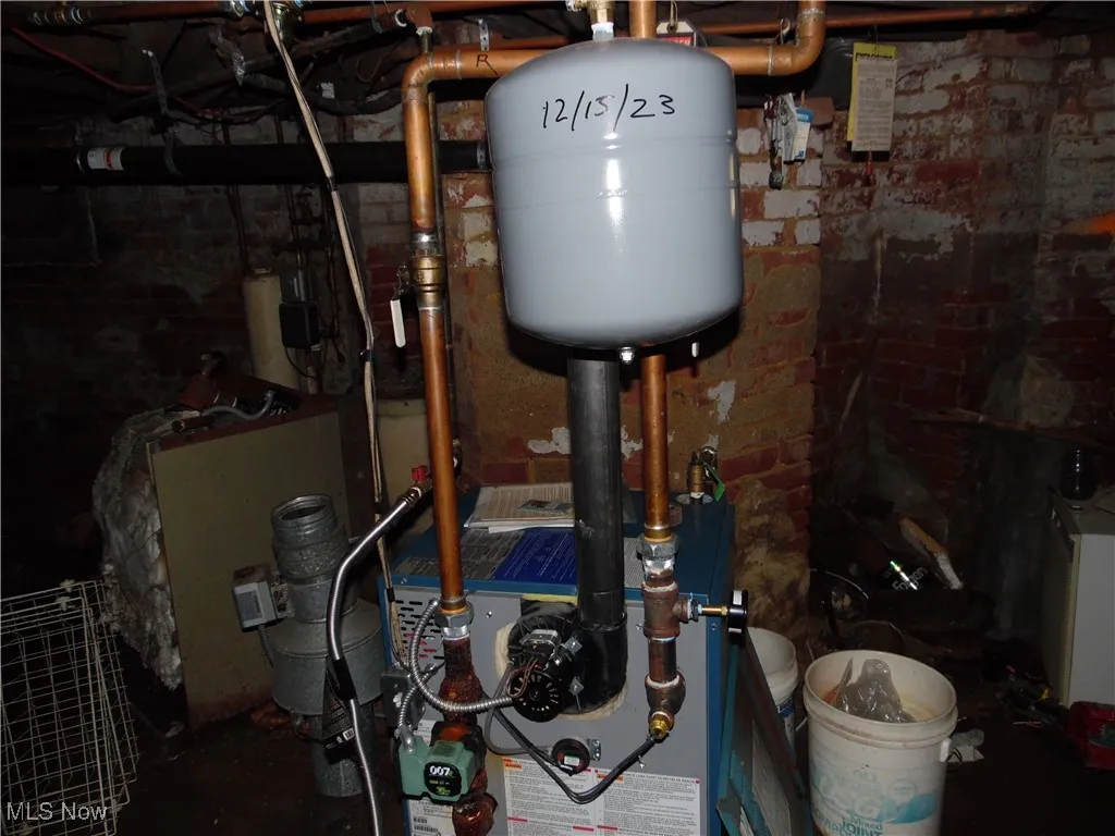 Utility room featuring a heating unit