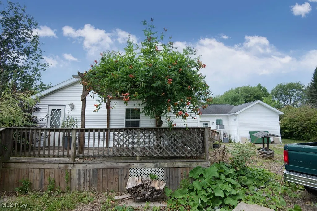 Back of house with a wooden deck