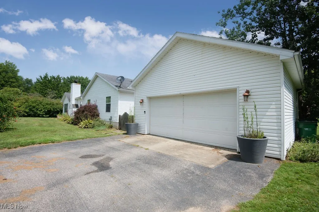 View of front of house with a front yard and asphalt driveway