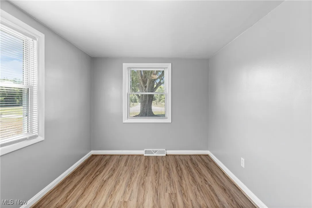 Unfurnished room featuring light wood-type flooring and baseboards