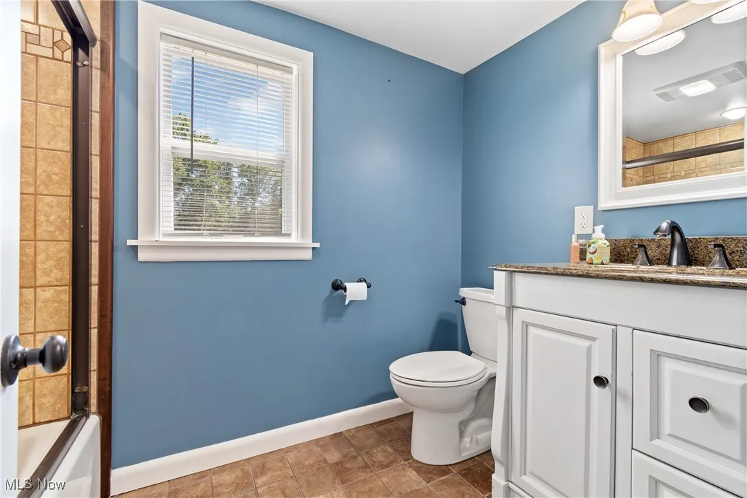 Full bathroom with shower / bath combination and vanity