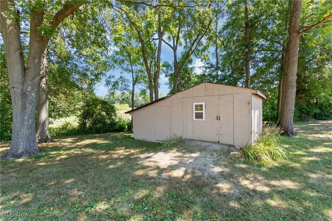 View of outdoor structure featuring view of wooded area