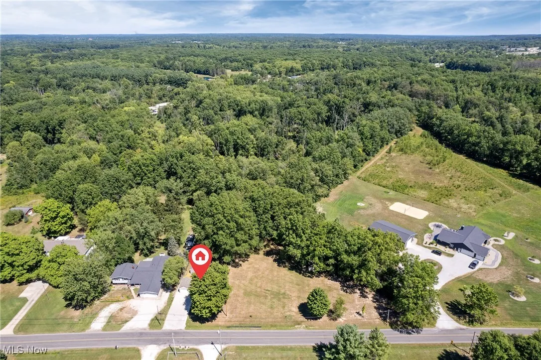 Aerial overview of property's location featuring a heavily wooded area