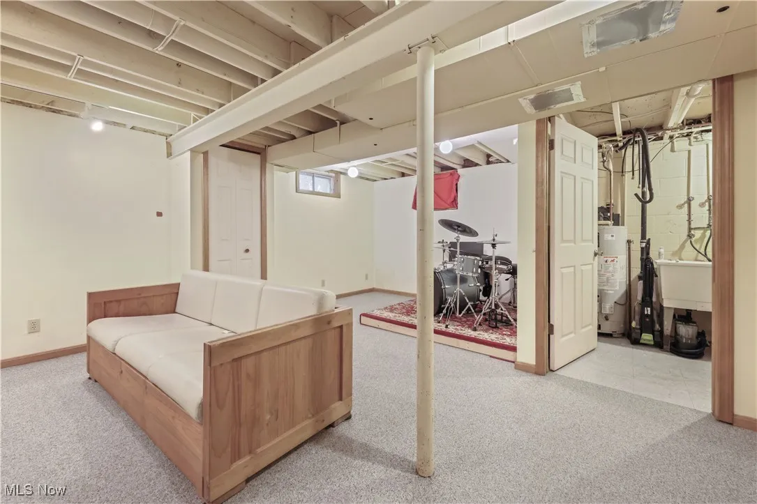 Below grade area with carpet and water heater