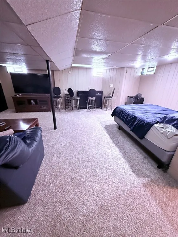 Carpeted bedroom with a drop ceiling