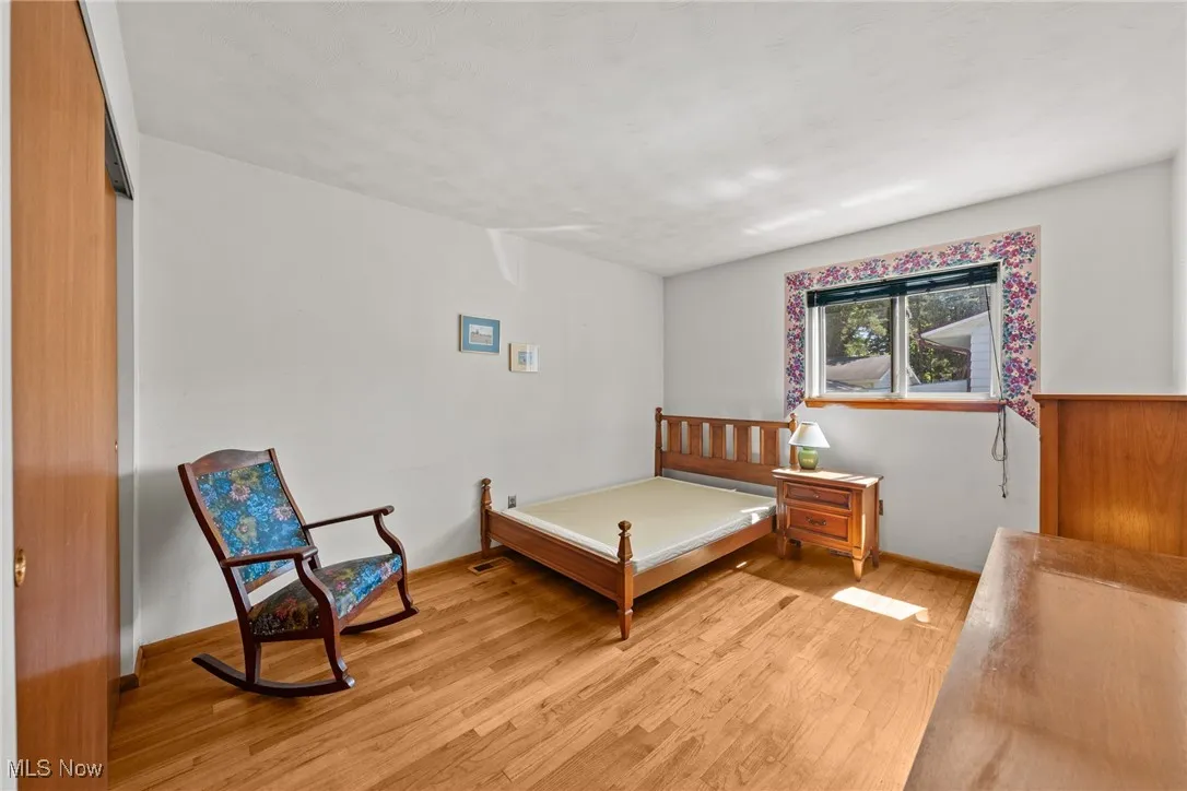 Bedroom featuring light wood finished floors and a closet