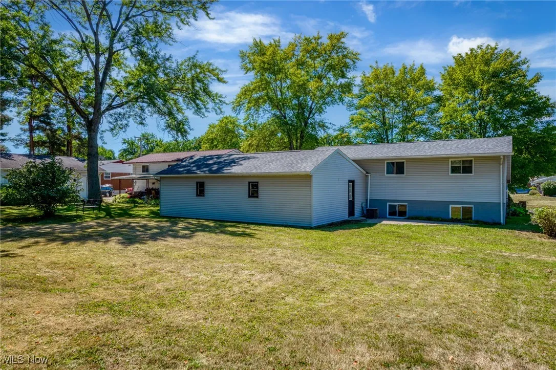 Rear view of house featuring a yard