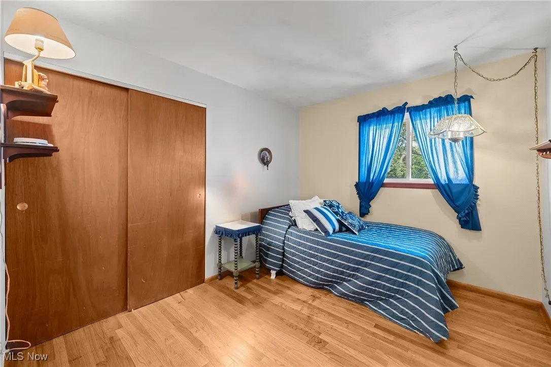 Bedroom with a closet and wood finished floors