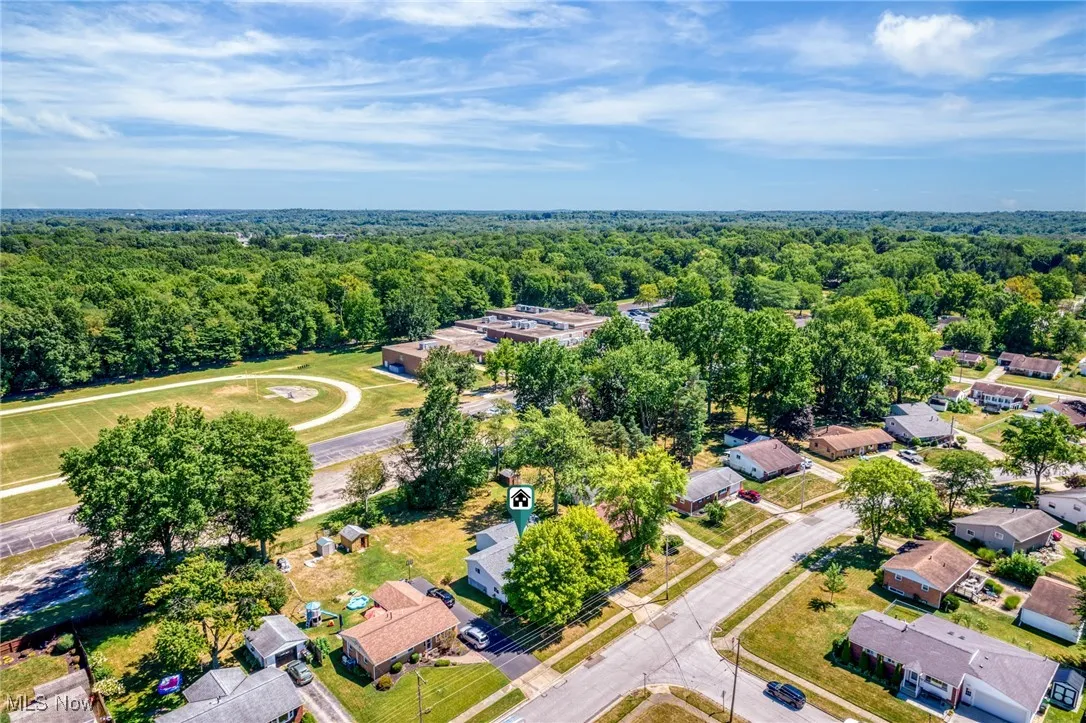 Aerial view of residential area featuring a forest