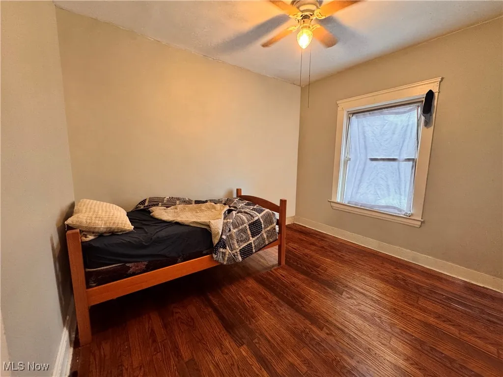 unit 4 Bedroom featuring ceiling fan and wood finished floors