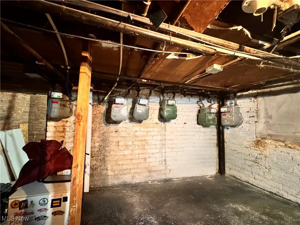 Unfinished below grade area featuring gas meter