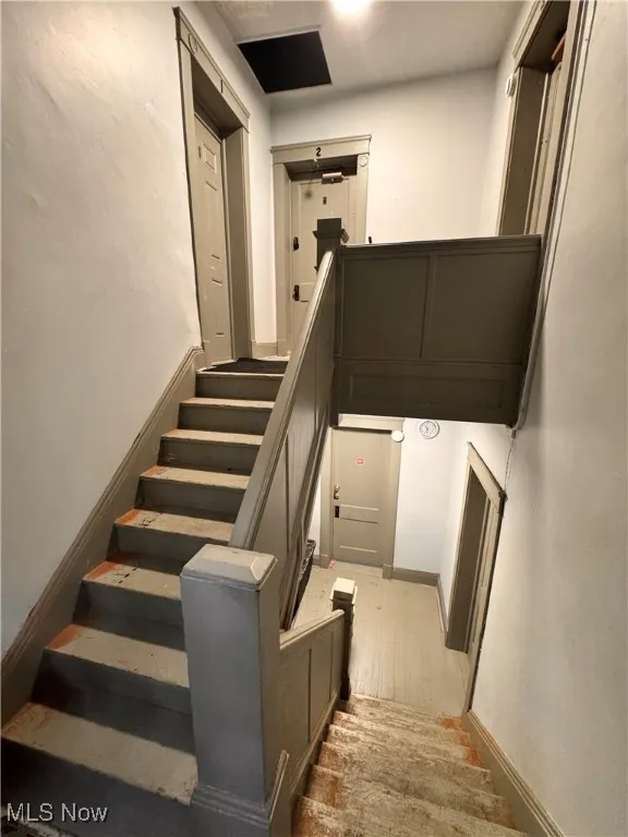 Stairs with baseboards and wood finished floors