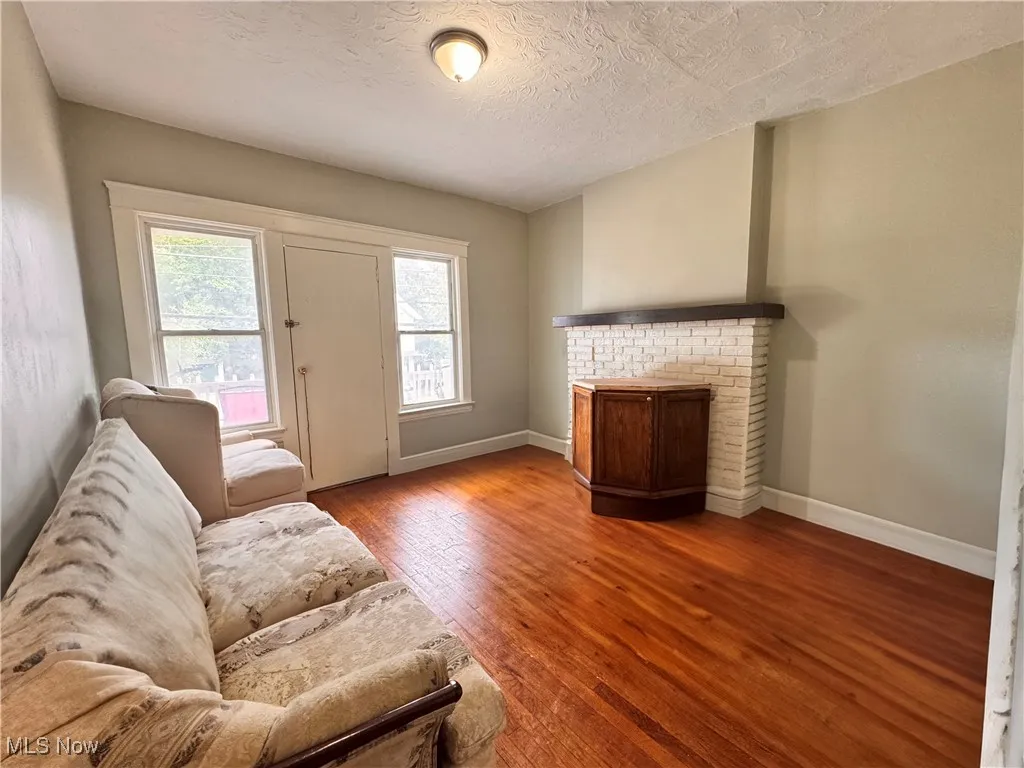 Unit 3 Living room featuring wood-type flooring and a textured ceiling
