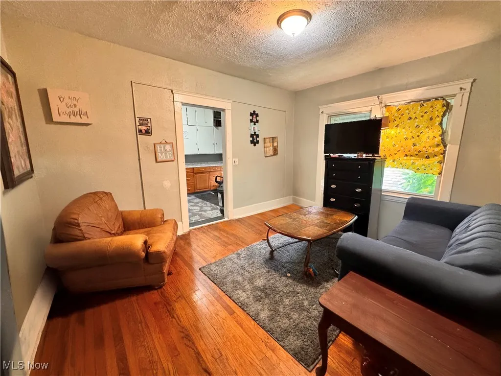 Unit 2 Living room featuring hardwood / wood-style floors and a textured ceiling