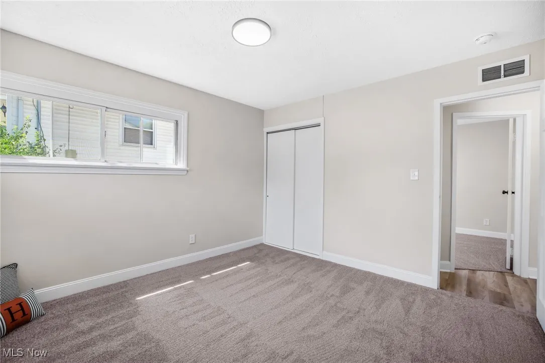 Unfurnished bedroom featuring carpet and a closet