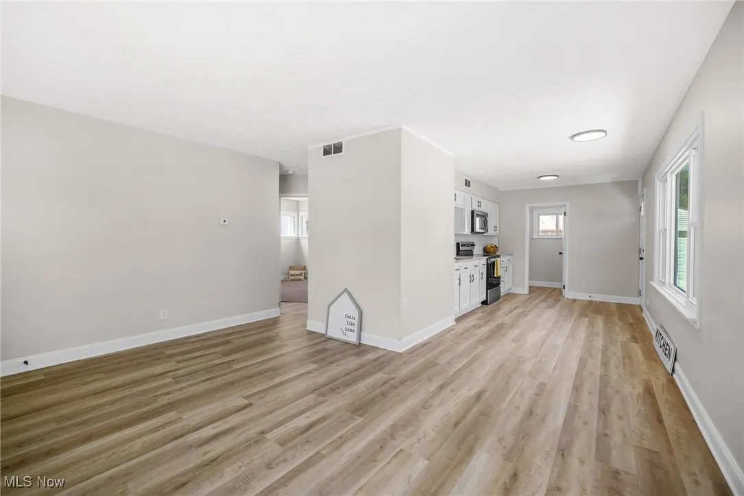 Unfurnished living room with light wood-type flooring