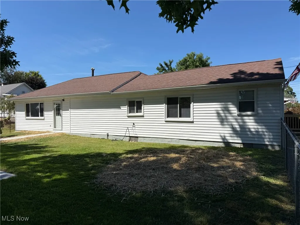 Rear view of house with roof with shingles