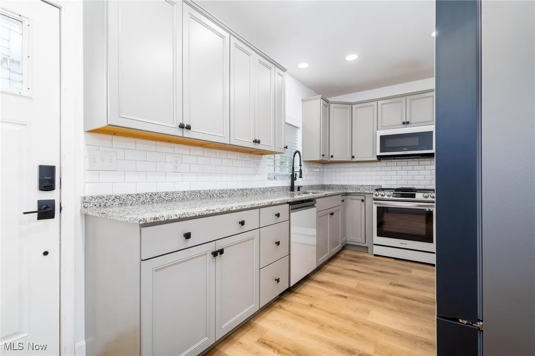 updated kitchen with granite counter tops, and  stainless steel appliances