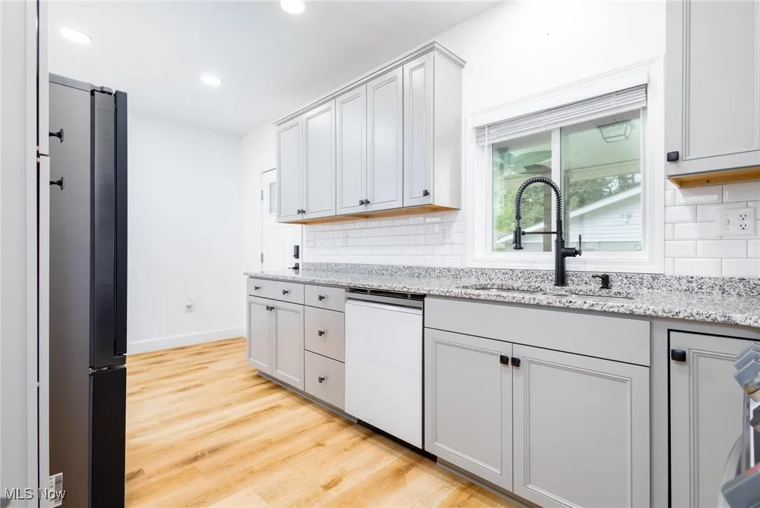 Kitchen with granite countertops and plenty of lighting