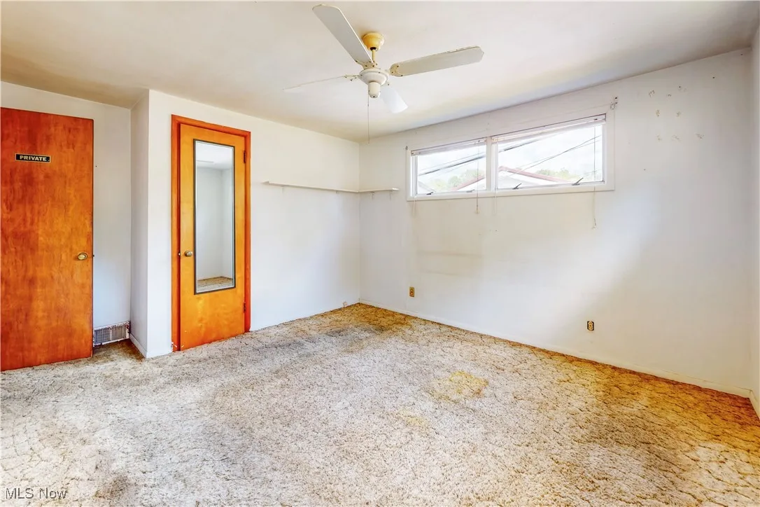 Unfurnished bedroom with carpet flooring and ceiling fan