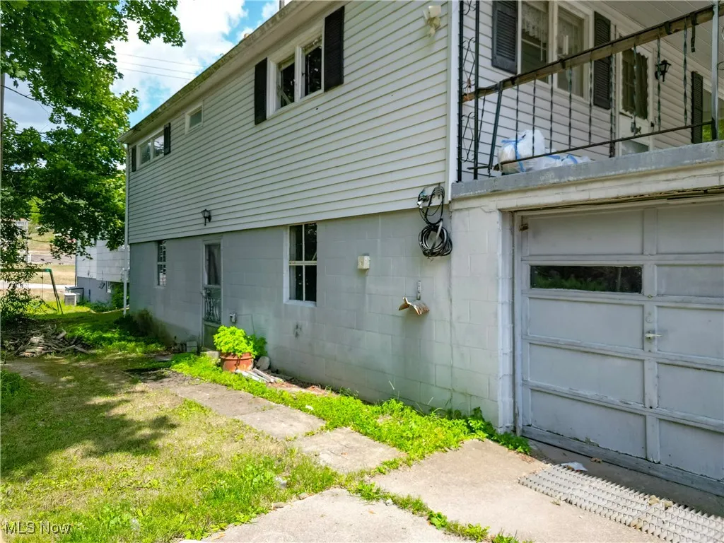 View of side of property with a balcony