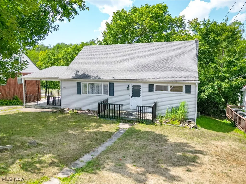 Rear view of property with a deck and roof with shingles