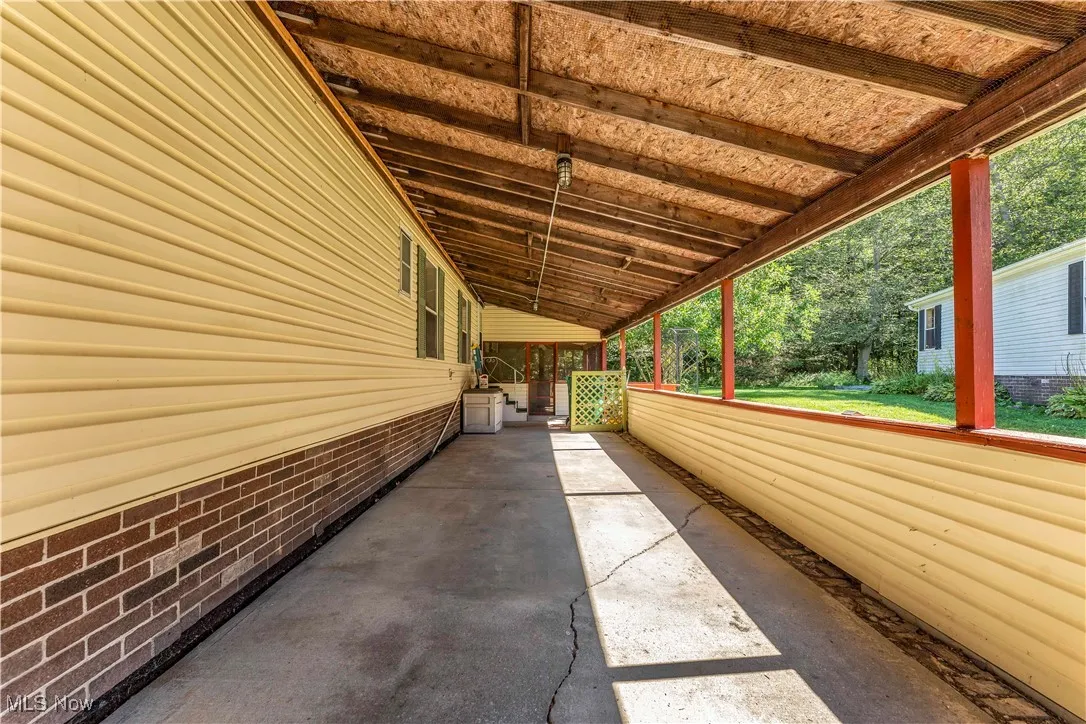 View of side of home featuring a patio area