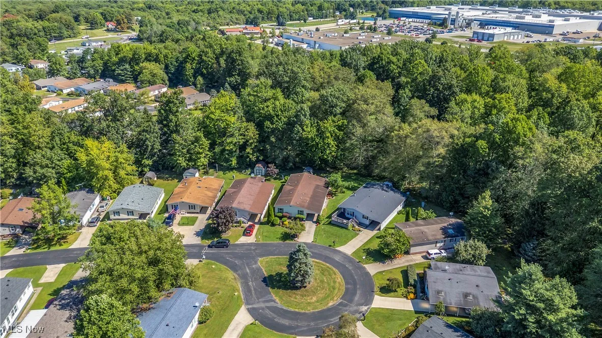 Aerial view of property and surrounding area with nearby suburban area