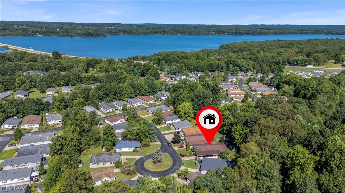 Aerial overview of property's location featuring nearby suburban area and a nearby body of water
