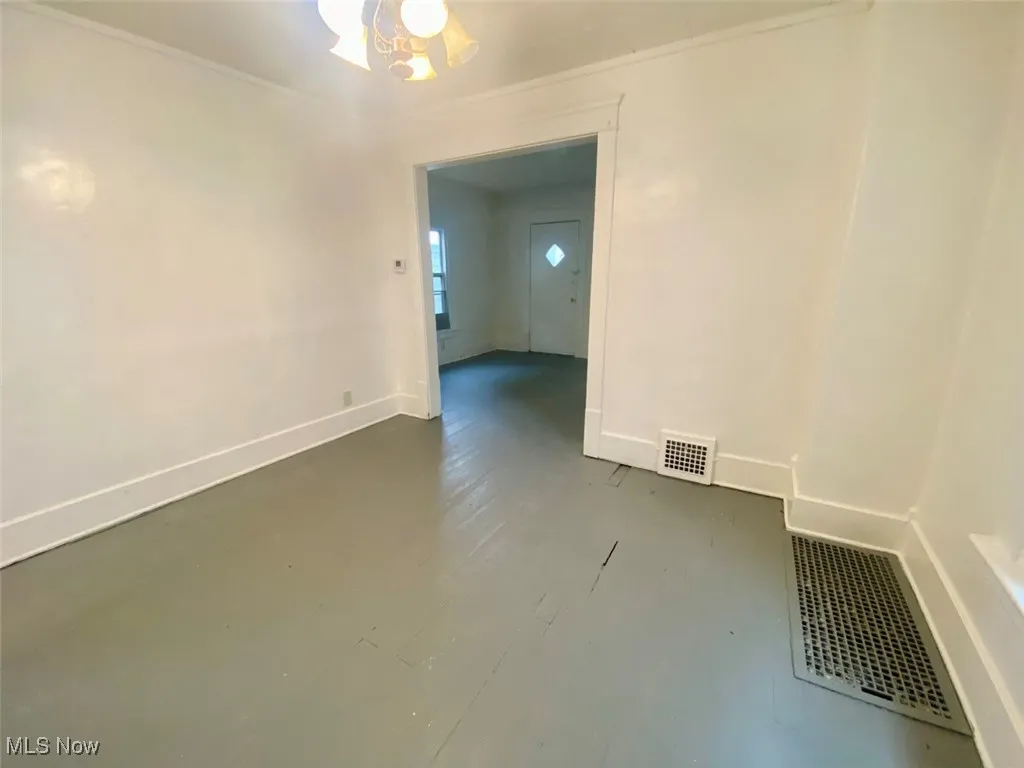 Spare room featuring baseboards and ornamental molding