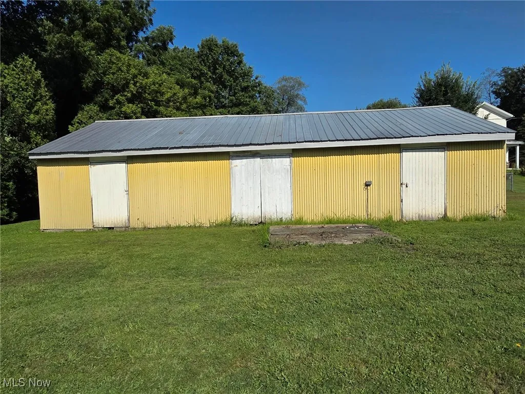 View of pole building with a lawn