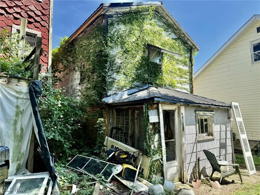 Back of house featuring a metal roof