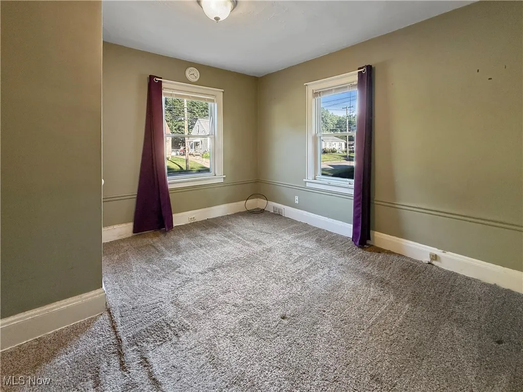 Bedroom with light carpet and plenty of natural light