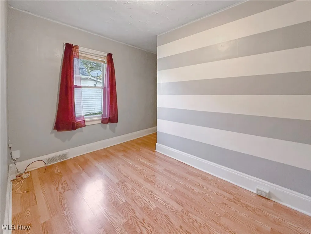 Bedroom with baseboards and light wood-style floors