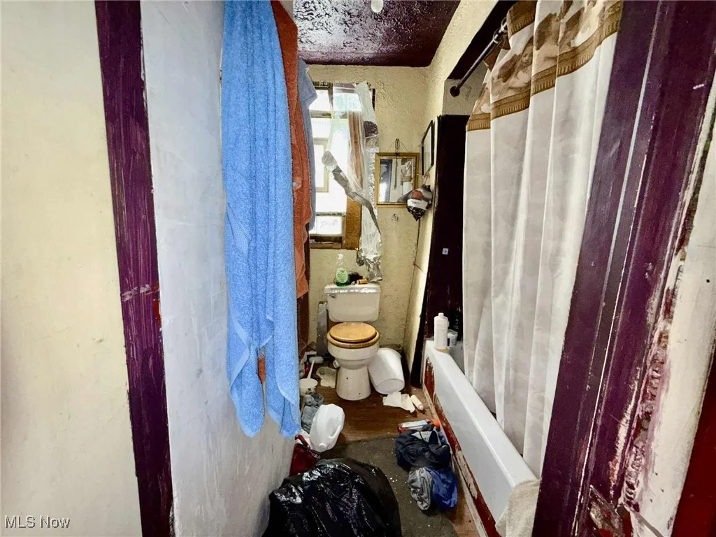 Full bath with shower / tub combo with curtain and toilet