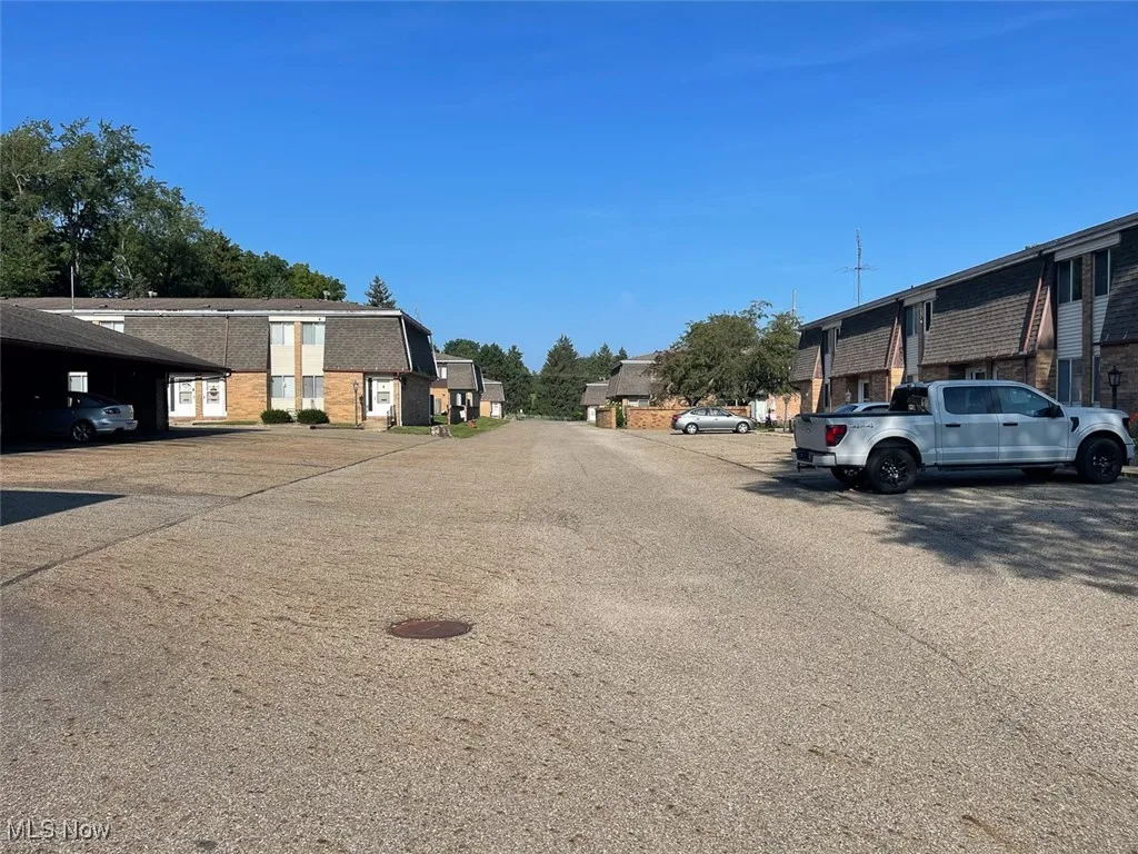 View of asphalt road featuring a residential view