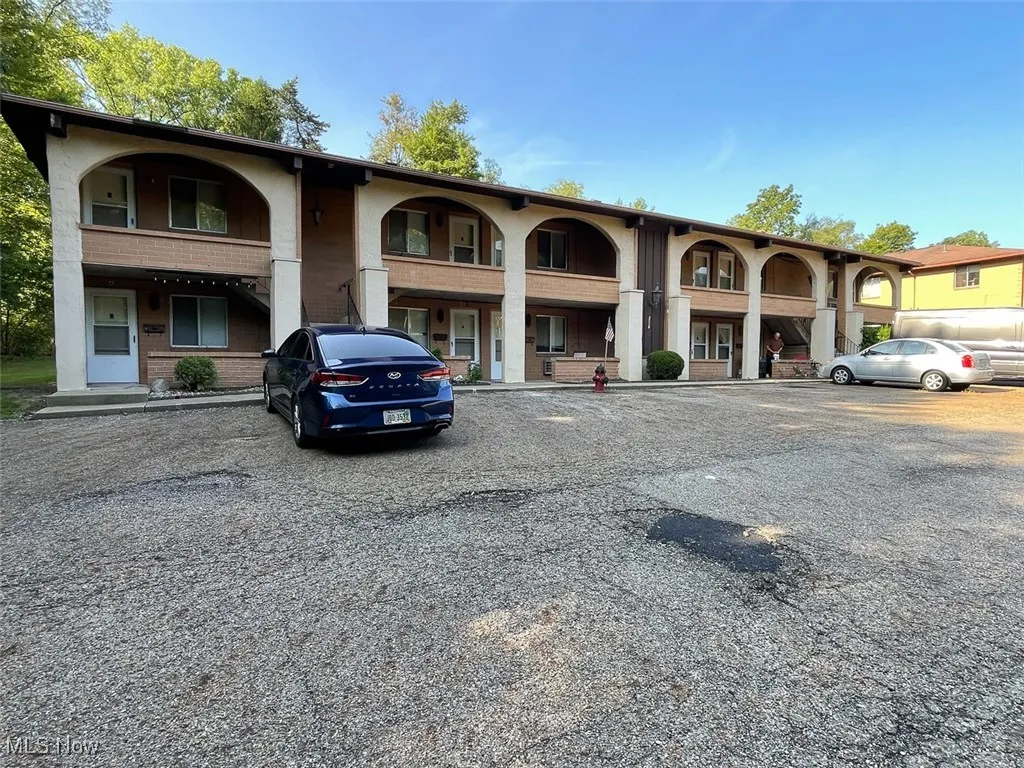 View of building exterior with uncovered parking