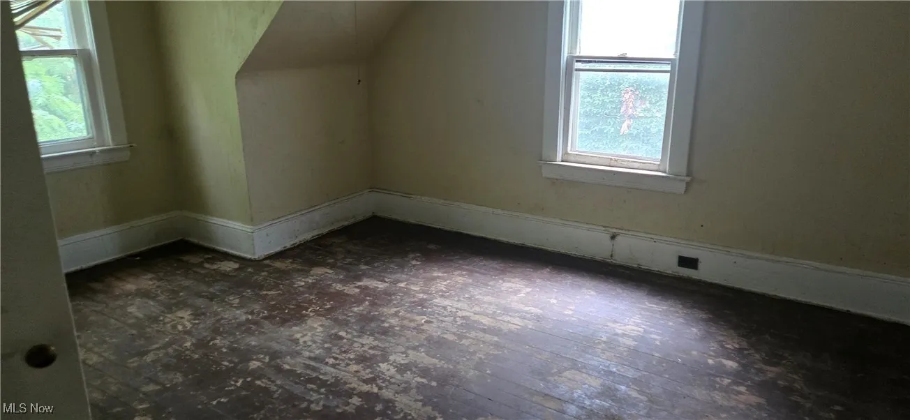 Additional living space with plenty of natural light and dark wood finished floors
