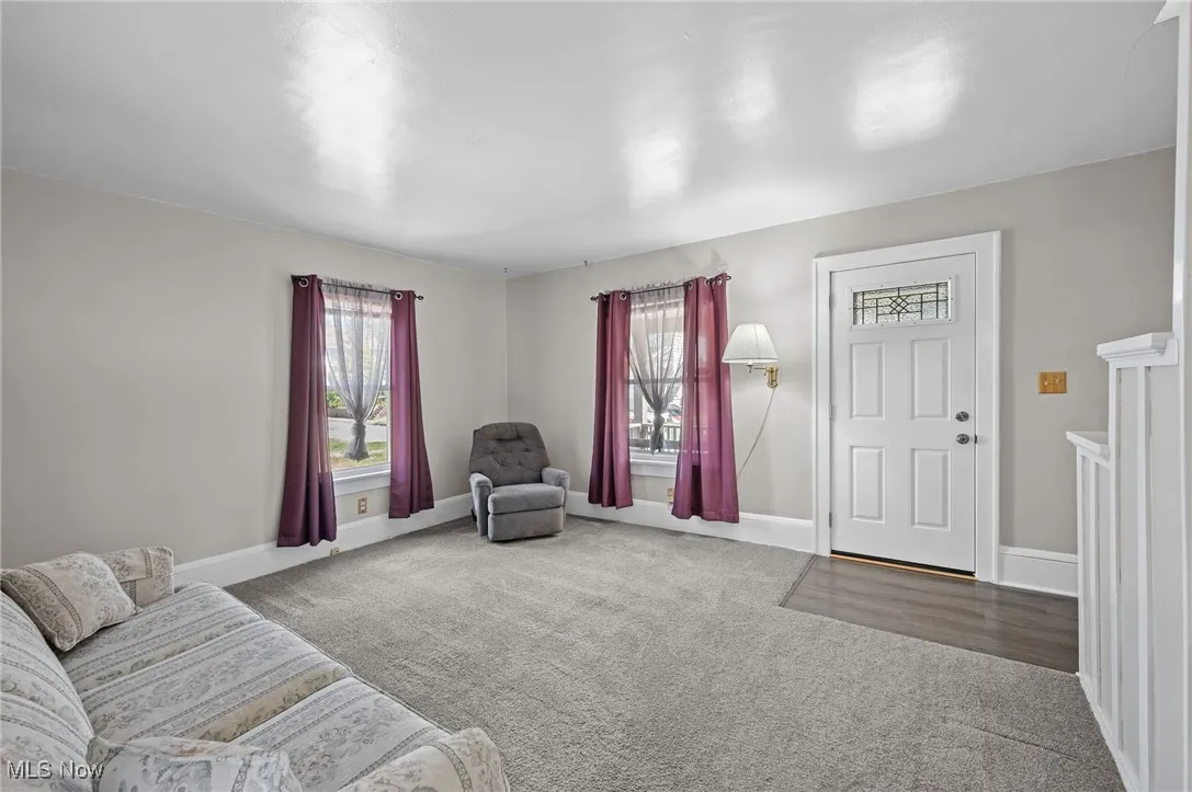 Living area featuring carpet and plenty of natural light