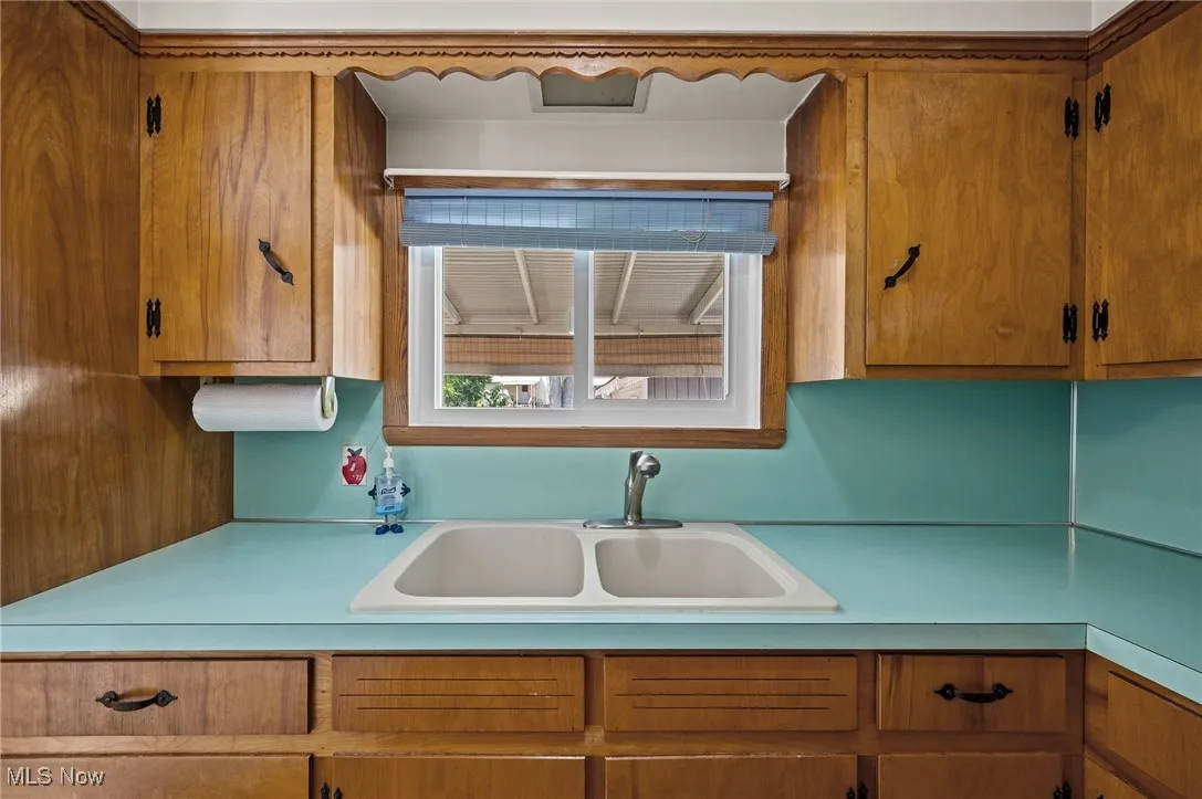 Kitchen with brown cabinets and light countertops
