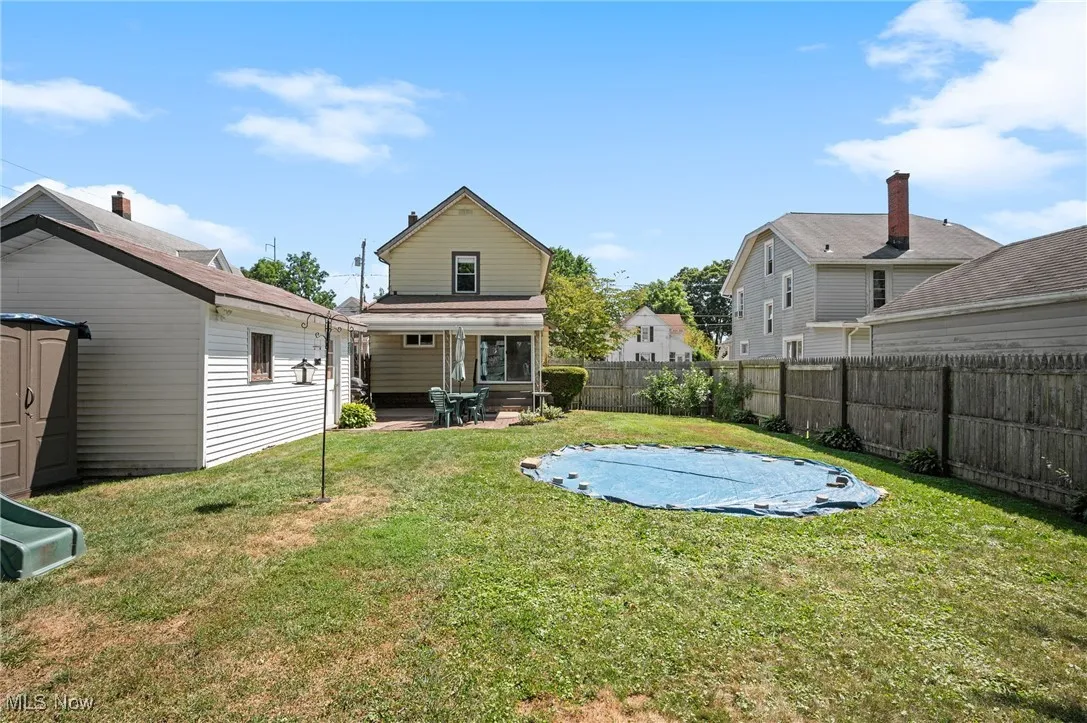 Fenced backyard with a patio