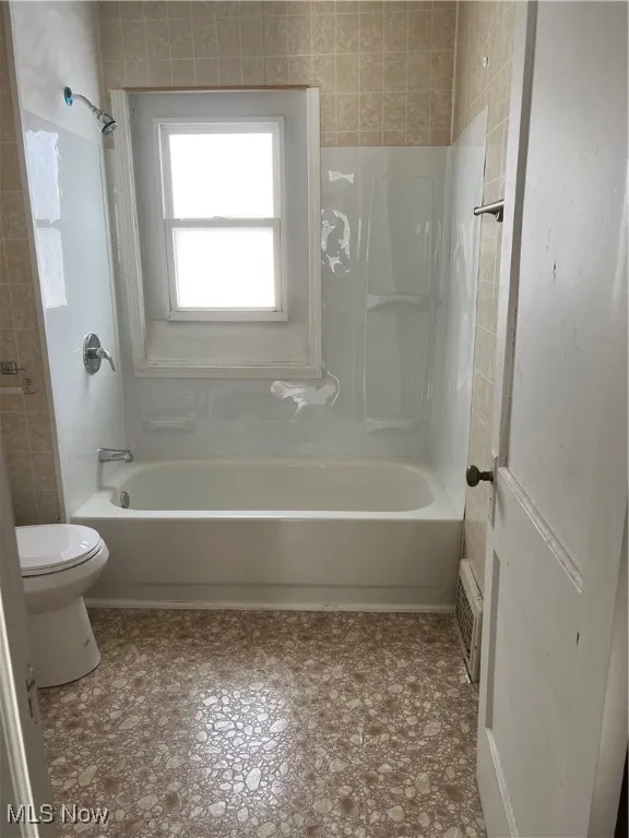 Full bathroom featuring bathing tub / shower combination and toilet