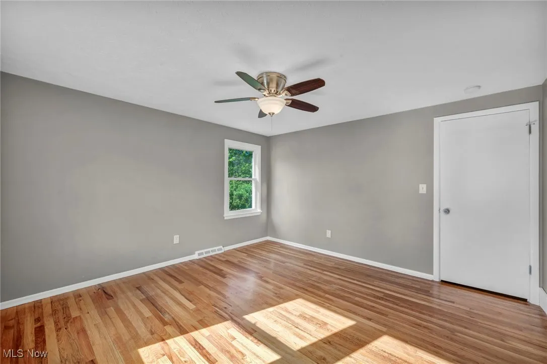 Unfurnished room with light wood-style floors and ceiling fan