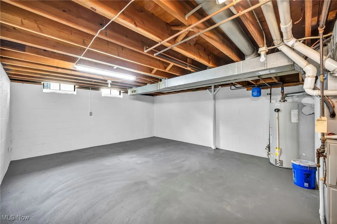 Below grade area featuring water heater