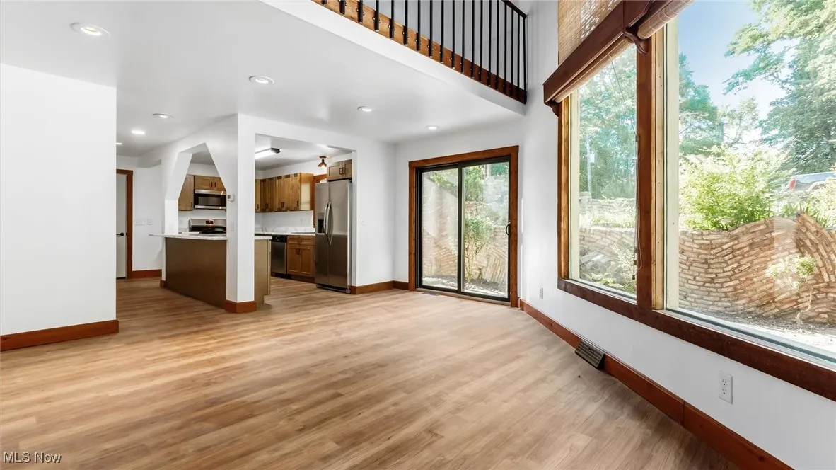 Unfurnished living room featuring light wood-style flooring and recessed lighting