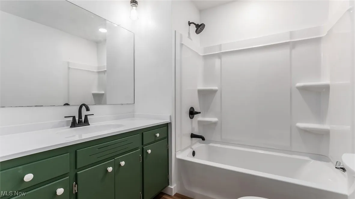 Full bathroom featuring shower / bathtub combination and vanity