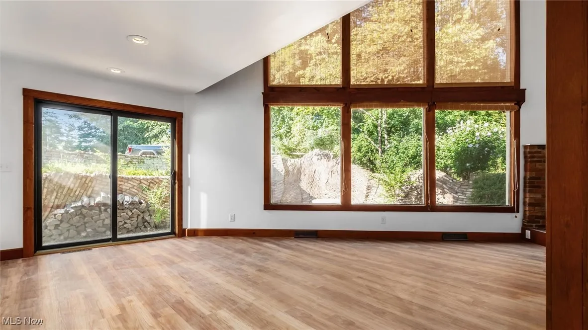 Unfurnished living room featuring light wood-type flooring and recessed lighting